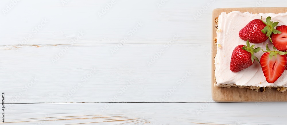 Aufkleber a piece of raw vegan strawberry cashew cake on a napkin placed on a white wooden surface is shown fr