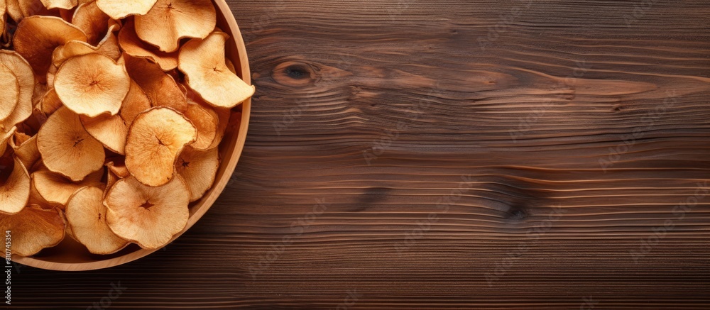 Poster an organic natural food consisting of dried apple chips is beautifully presented in a close up top v