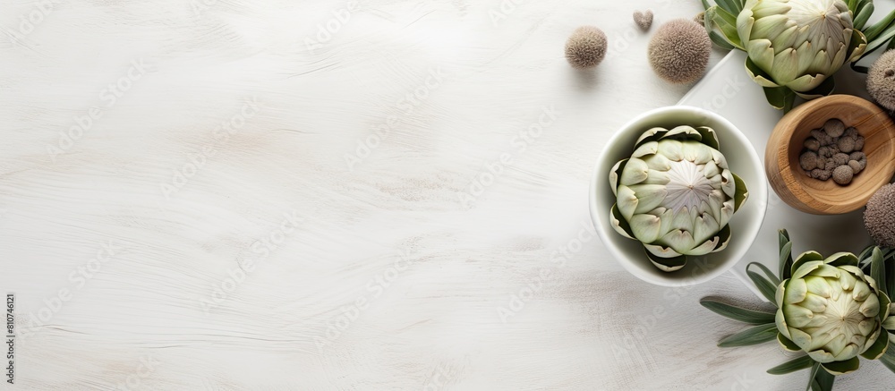 Poster The white wooden table is adorned with a bowl filled with powder and fresh artichokes creating an appealing flat lay composition Ample space is available for text