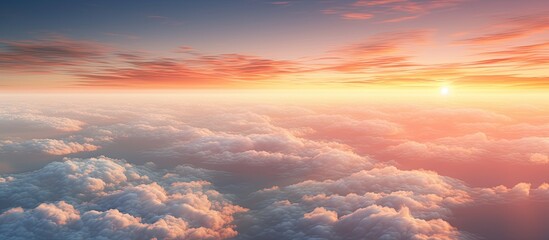 A blurred and noisy copy space image showcases the fiery red sky at great altitude with the sunset reflecting off clusters of dense fluffy white clouds as seen from an airplane window