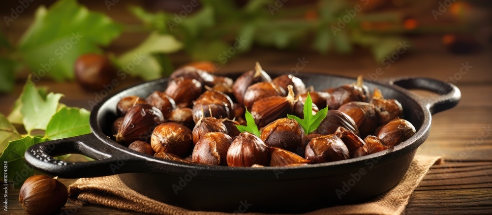 Aufkleber Chestnuts perfectly roasted and served in a rustic chestnut pan rest on a vintage table creating a charming copy space image
