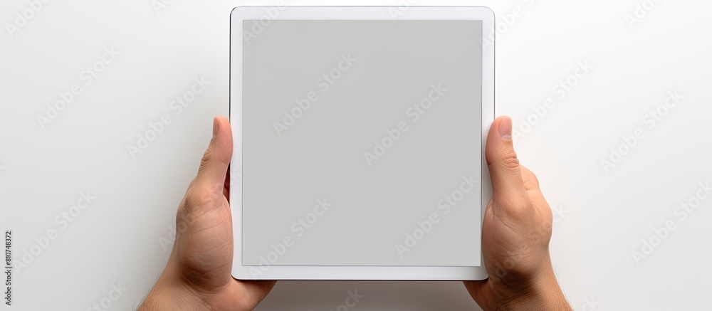 Poster A white background with a hand holding a tablet PC featuring a blank screen to insert an image. Creative banner. Copyspace image