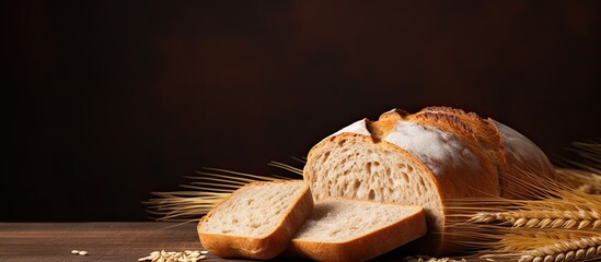 Copy space image of whole wheat bread on a brown background - obrazy, fototapety, plakaty