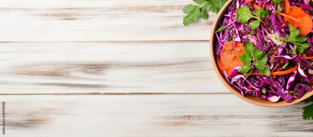 Aufkleber Top view of a detox salad made with red cabbage carrots and pomegranate accompanied by a flavorful cilantro dressing Presented on a white wooden background with ample space for copy