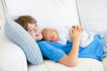 Child holding newborn sibling