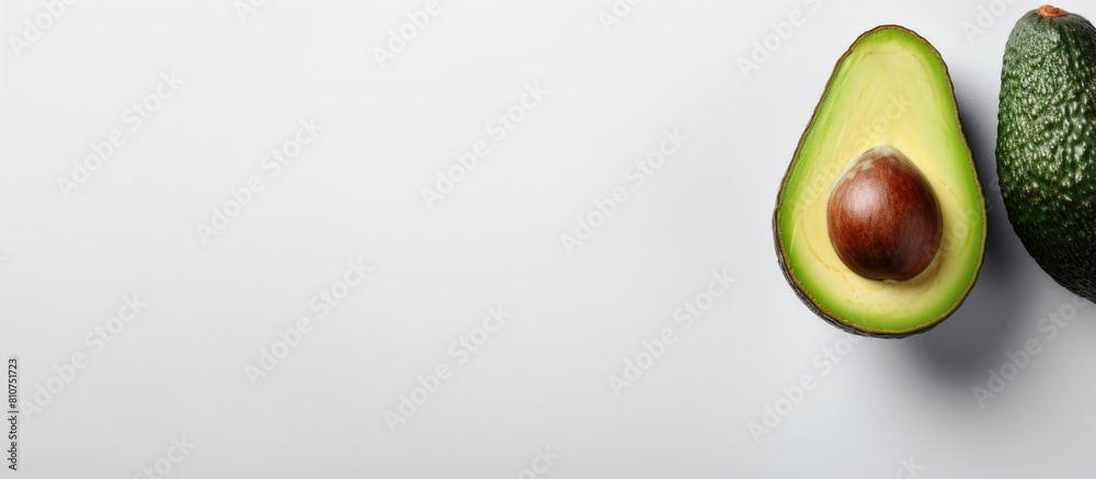 Poster A top view of a whole avocado on a light background with a frame that provides space for text. Creative banner. Copyspace image