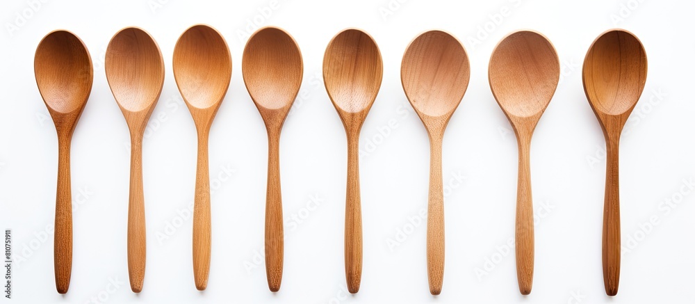 Poster A simple and clean image showcasing wooden spoons on a white background with plenty of copy space