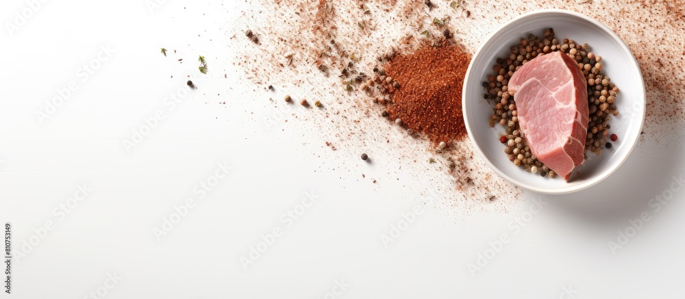 Poster copy space image of a ceramic plate with flakes spices on a white putty background featuring raw org