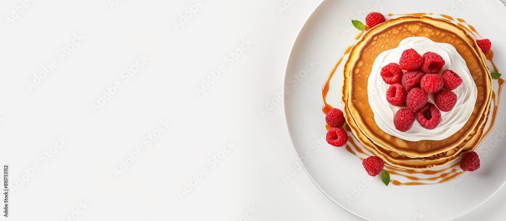 Poster top view of fluffy pancakes topped with fresh raspberries presented on a white ceramic plate with am