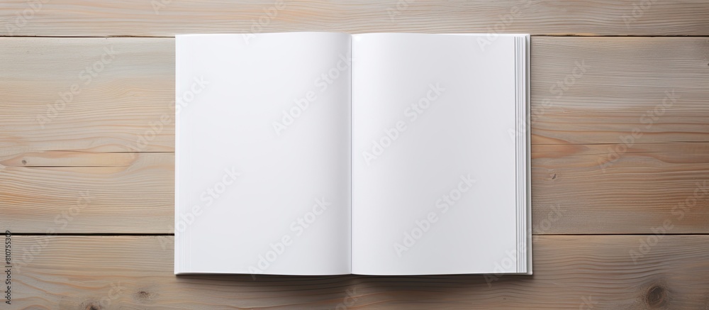 Aufkleber a blank book cover template with an open page on the front side positioned on a white wood backgroun