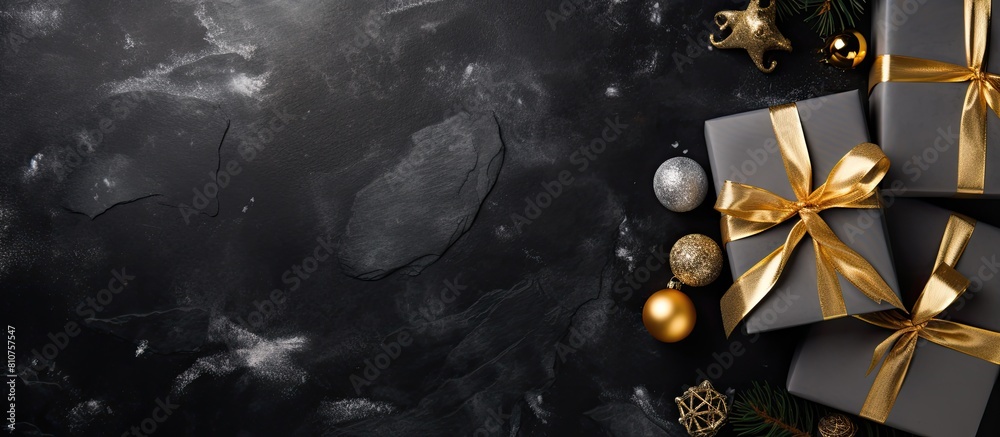 Poster top view of a black stone background adorned with gold and silver decorations and a present box crea
