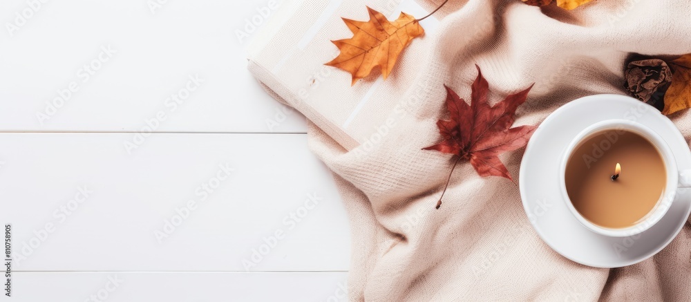 Poster a cozy autumn home composition with dried leaves a cup of coffee a book a scarf and flowers on a whi