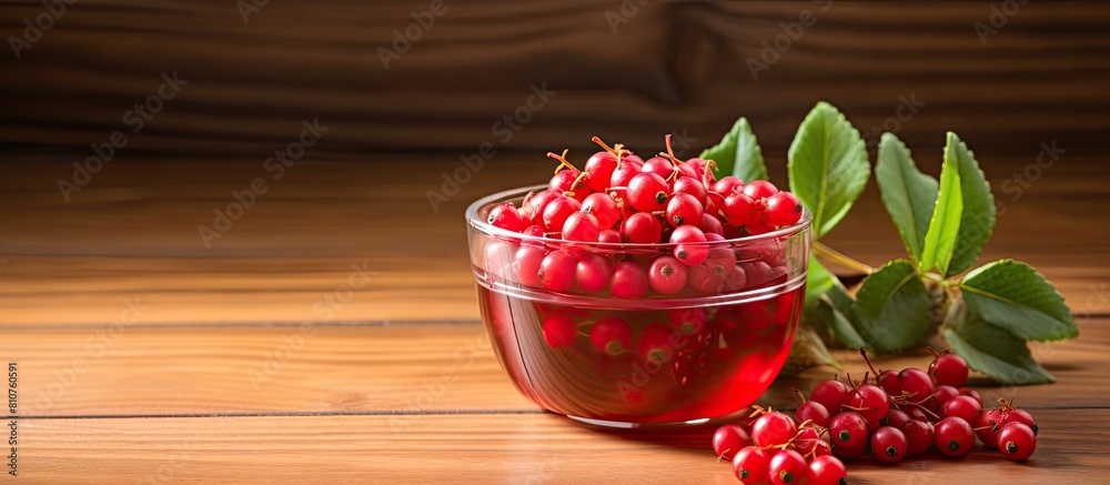 Poster A revitalizing cocktail of honeysuckle berries is displayed in a small bowl against a natural wood background providing plenty of space for adding text. Creative banner. Copyspace image