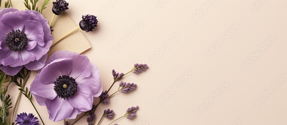 Aufkleber top view flatlay of a beige background with a purple flower anemone envelope and greeting card mocku
