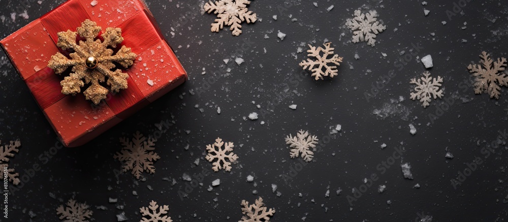 Poster An aerial snapshot of a Christmas gift box decorated with snowflakes captured from above with a flat perspective There is ample copy space in the image