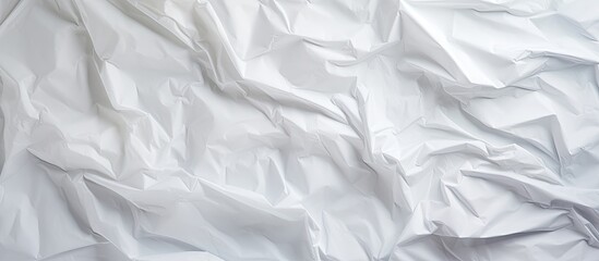 Fototapeta premium Top view of a crumpled white paper with a textured surface creating an interesting copy space image
