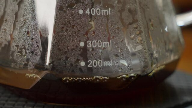 Fresh Hot Black Coffee Dripping in Coffee Maker Glass Pot, Close Up