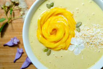 Mango pineapple smoothie bowl made with coconut milk mango pineapple and banana topped with mango...
