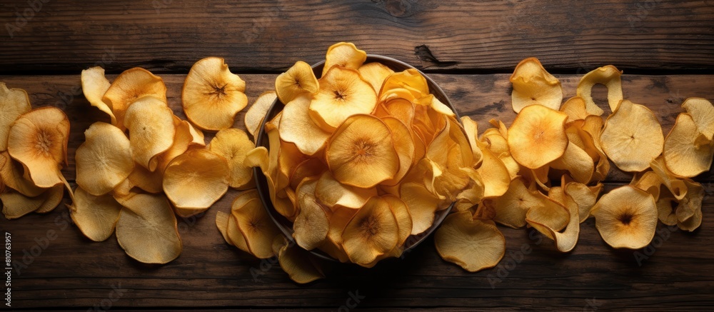 Poster an organic natural food consisting of dried apple chips is beautifully presented in a close up top v