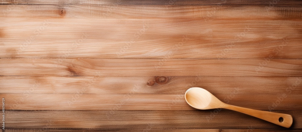 Aufkleber top view of a wooden table with a close up shot of a cooking wooden spatula and lined paper creating