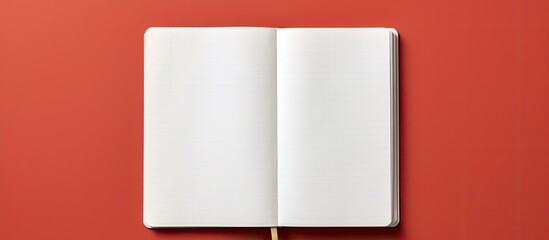 A copy space image of an empty notebook photographed from a top down perspective on a bicolor background