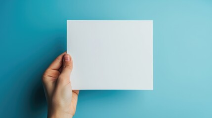 Fototapeta premium A Hand Holding a Blank White Card