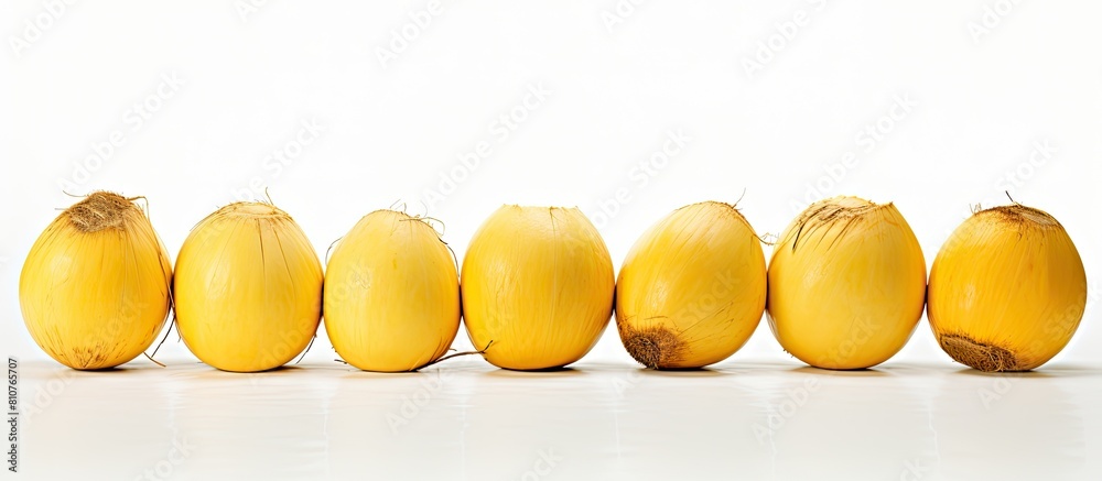 Poster copy space image of yellow coconuts against a white backdrop