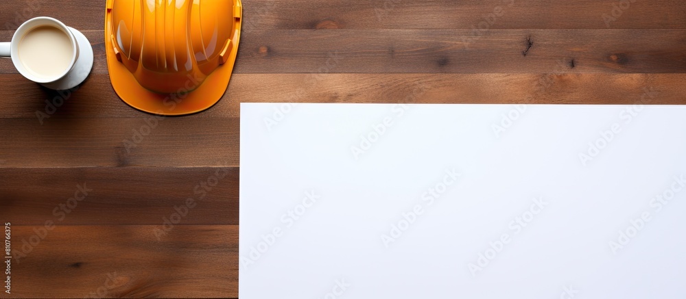 Leinwandbilder a top down view of a brown wooden table displaying a white sheet of paper alongside an orange safety