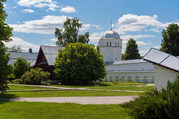 View of the walls and tower of the Holy Intercession Convent and its courtyard on a sunny summer...