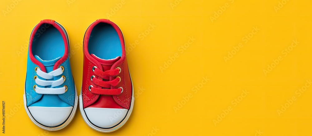 Poster a top view photo of a pair of child s shoes placed on a colorful background ready for use as a flat 
