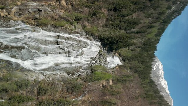 Drone flying toward Nardis Waterfall, Trentino, Italian Alps, Italy. Aerial forward and Vertical Format