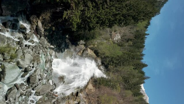 Drone flying over Nardis Waterfall, Trentino, Italian Alps, Italy. Aerial forward ascending and Vertical Format