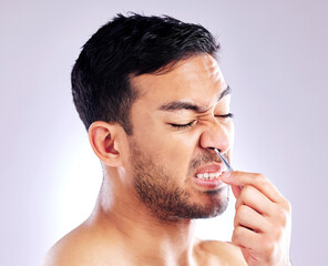 Tweezers, man and remove nose hair, grooming and hygiene on white studio background. Person, model...
