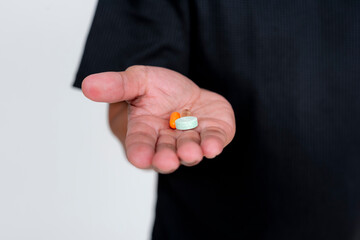 Middle aged Asian man showcasing nutritional supplements, isolated on white