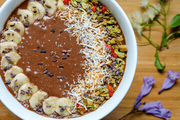  Healthy Raw Cacao chocolate smoothie bowl topping with cacao nibs and cacao granola goji berry banana and orange