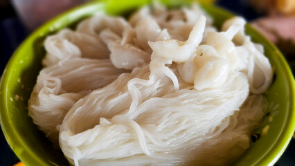 Macro shot of freshly cooked fermented rice flour noodles, offering a unique texture and flavor...