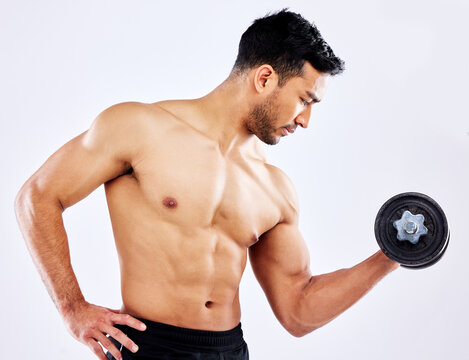 Muscular man, fitness and weightlifting with dumbbell for workout, strength or muscle gain on a gray studio background. Profile of young male person or active bodybuilder with bicep curl for exercise