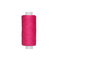 pink spool of sewing thread isolated on white background close up