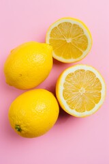 Vibrant yellow lemons on a pink background