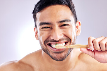 Grooming, portrait and man with toothbrush for teeth, wash and routine of hygiene in morning and dental. Oral health, wellness and person with smile in white background, studio and cleaning of tooth
