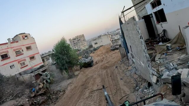Israeli military armed vehicles, military tankers driving on bombed and destroyed street of Gaza during Israel Hamas war conflict, 2024