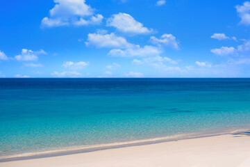 Nature of the beach and sea Summer with sunshine, sandy beaches, clear blue waters sparkling against the blue sky. On an island with good ecology and environment Background for summer vacation concept