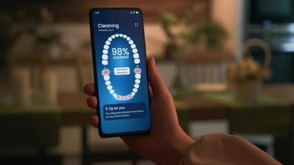 Smart electric toothbrush gives personal tips on dental care. Using a sonic electric toothbrush connected to a smartphone app.