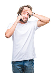 Handsome hispanic man model talking on smartphone over isolated background stressed with hand on head, shocked with shame and surprise face, angry and frustrated. Fear and upset for mistake.