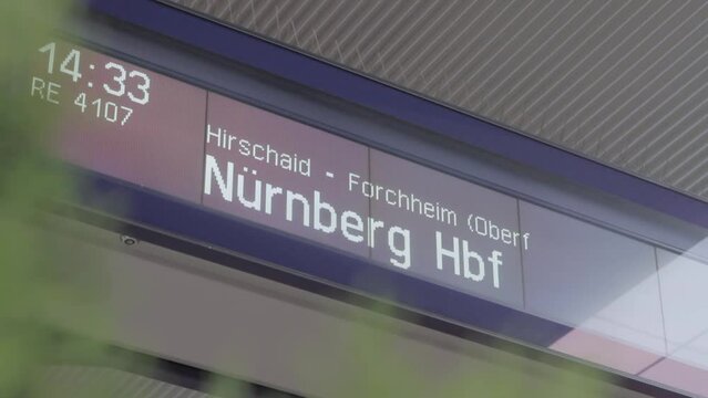 Close-up of a digital train departure board at a station showing N&uuml;rnberg Hbf