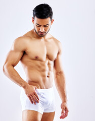 Fitness, muscle and man in underwear on studio, white background or bodybuilder abdomen. Healthy,...