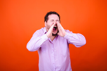 Joy, surprise and anger. Funny adult man posing in studio against orange background.