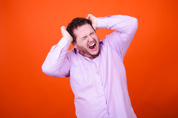 Joy, surprise and anger. Funny adult man posing in studio against orange background.