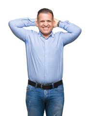 Fototapeta premium Middle age arab business man over isolated background Relaxing and stretching with arms and hands behind head and neck, smiling happy