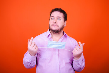 Funny adult man and a cold. Orange background.